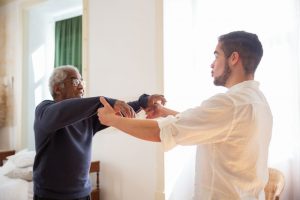 Caregiver supporting an older adult wellness plan
